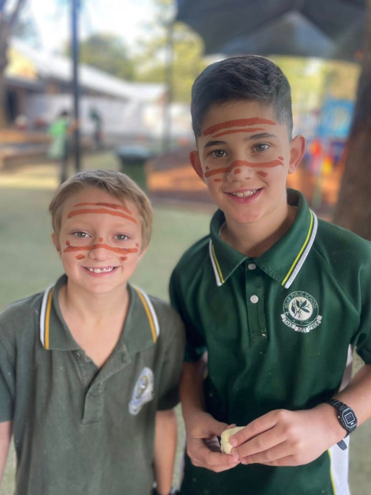Two students with indigenous face paint for NAIDOC week