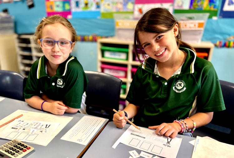 two girls working at a desk